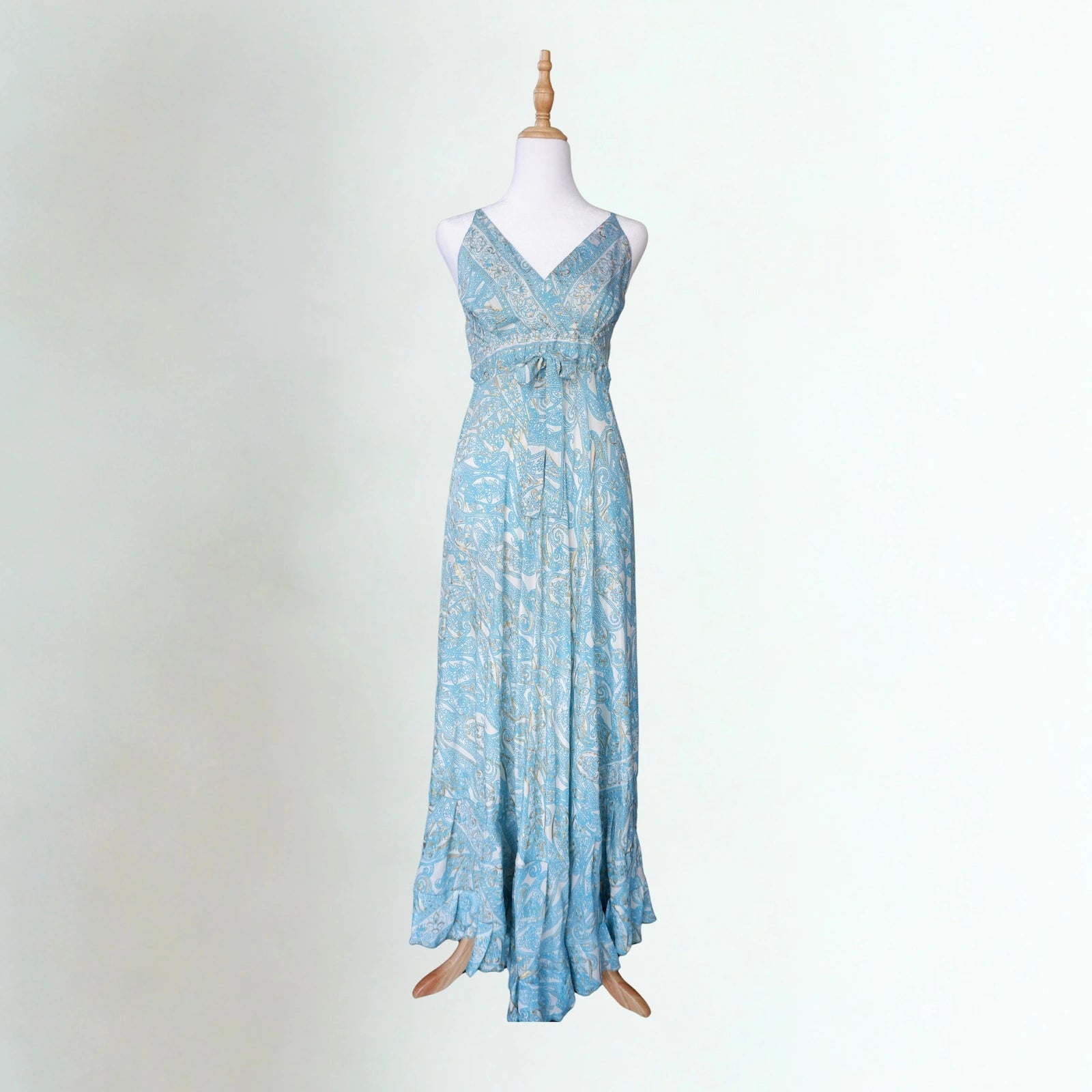 Blue paisley dress with white and gold detail on a mannequin with a white background
