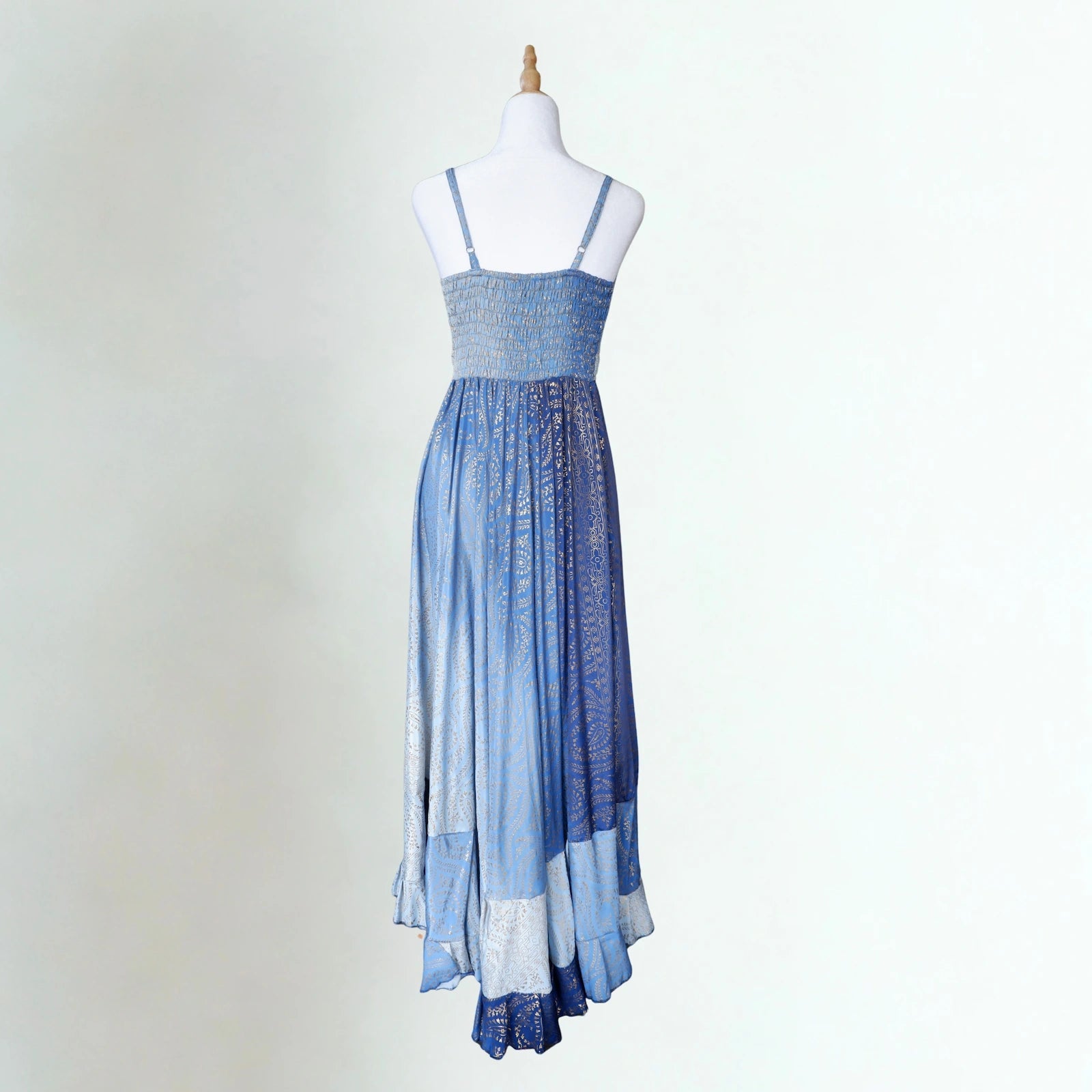 Blue gradient dress on a mannequin against a white background