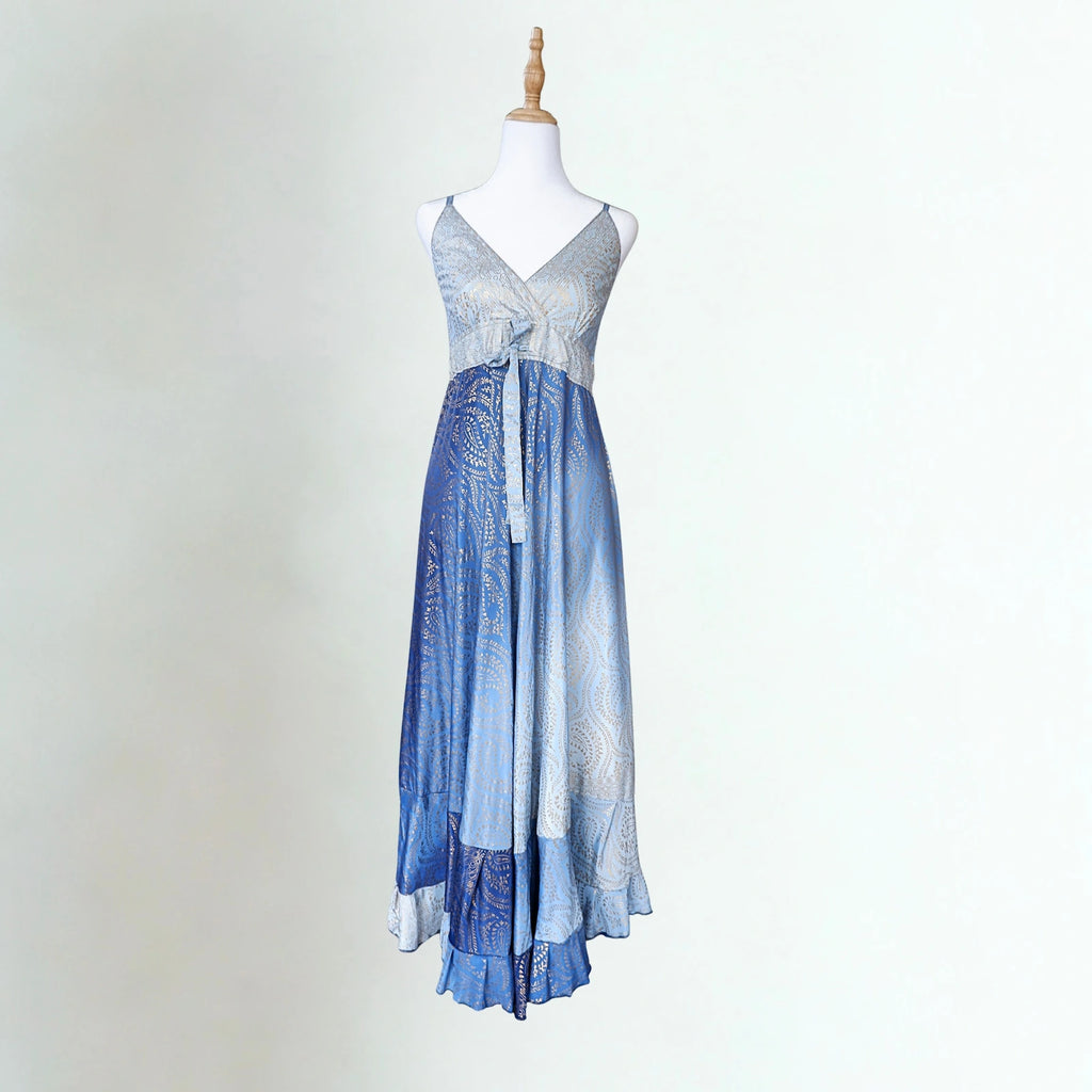 Blue and white dress on a mannequin against a plain background