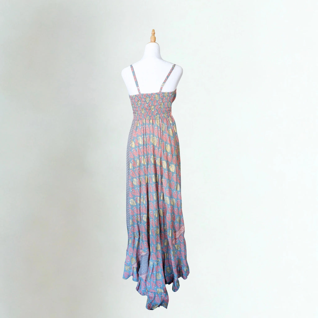 Multicolored patterned dress on a mannequin against a plain background