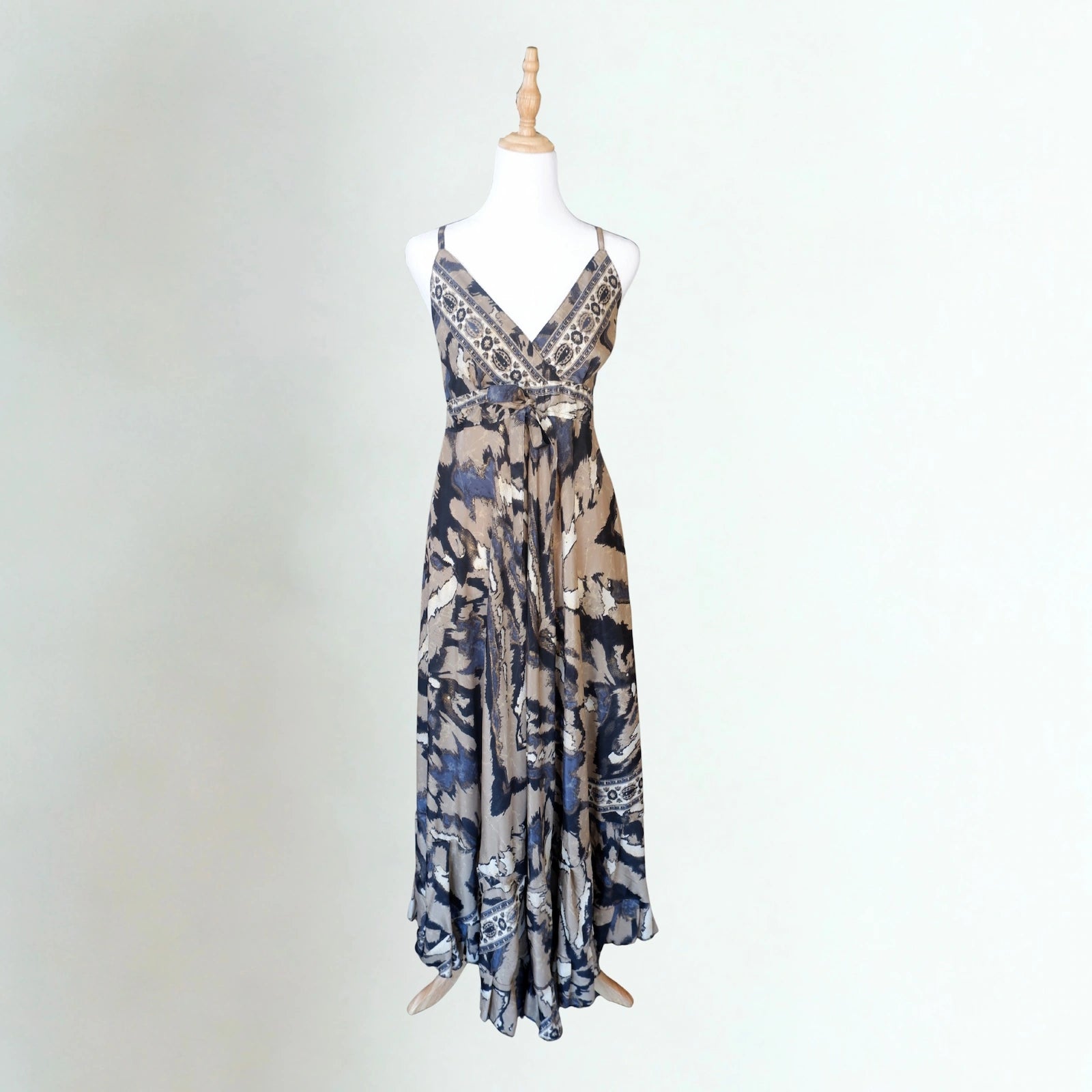 Patterned dress on a mannequin against a white background