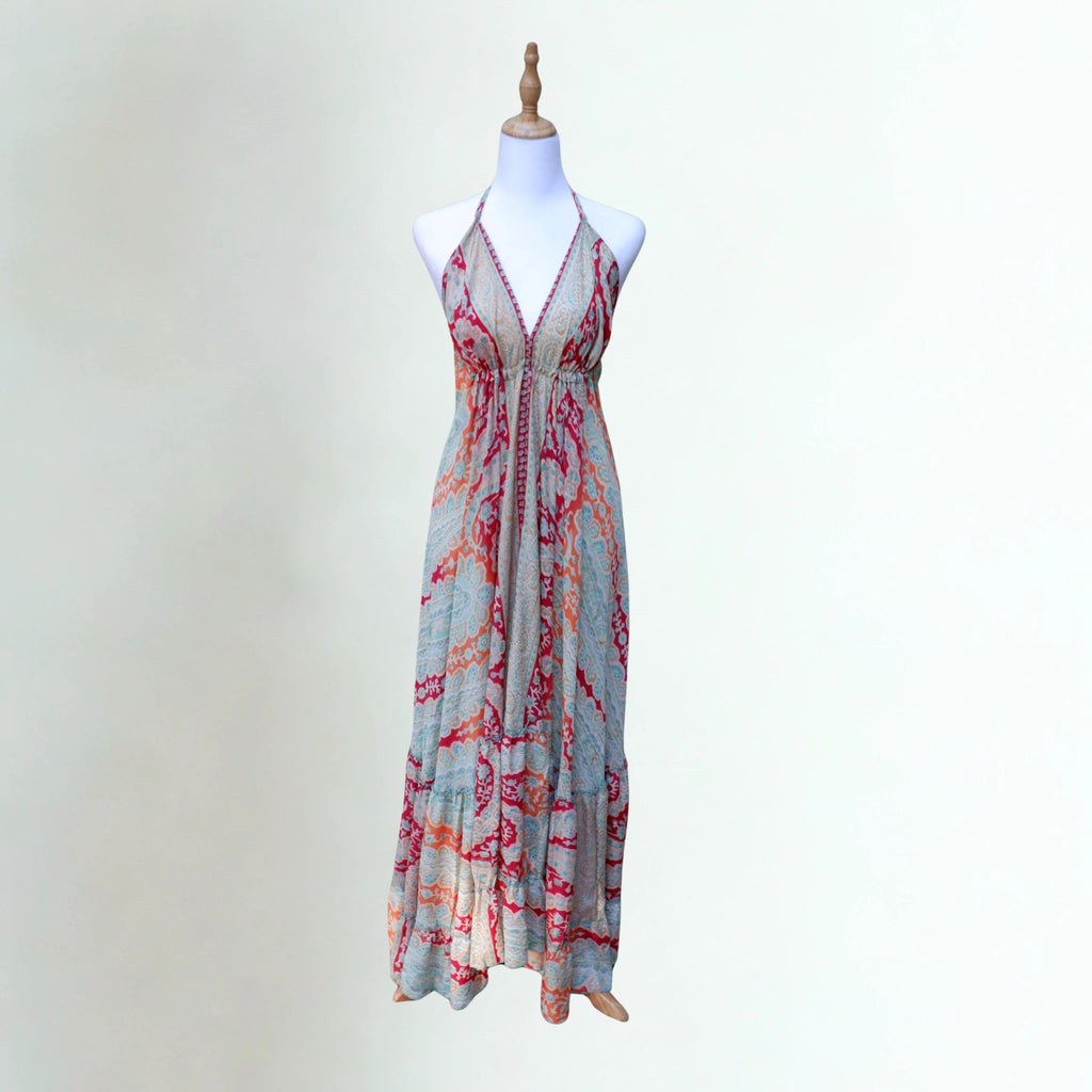 Elegant breathable silk summer dress in teal and amber organic paisley, open back and adjustable halter neck ties on a mannequin.
