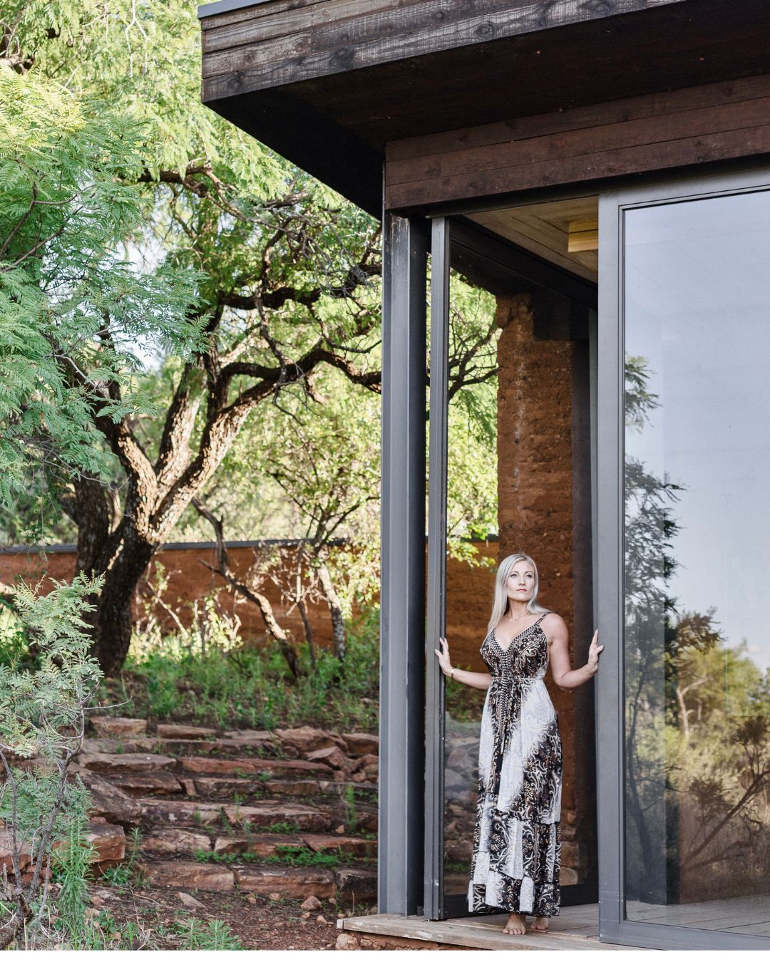 woman in silk dress standing in a doorway