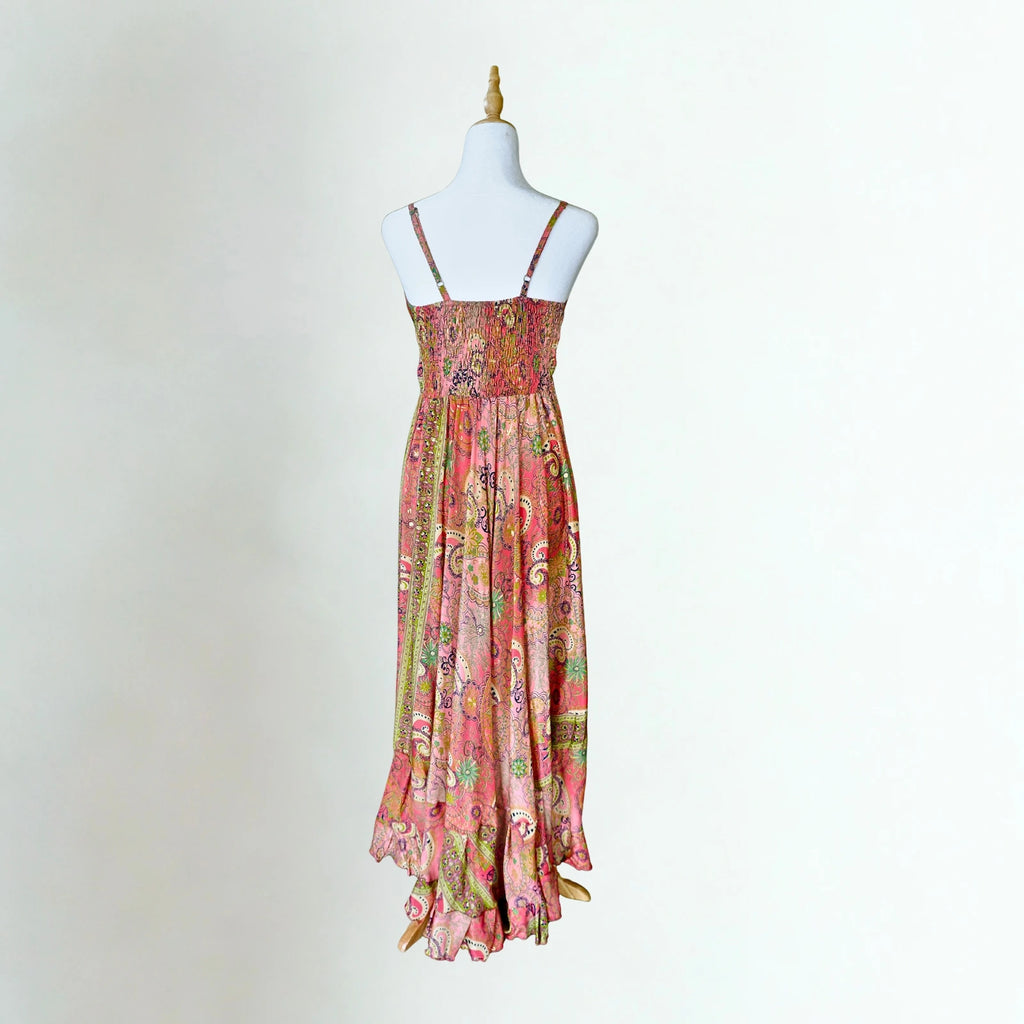 coral pink silk dress on mannequin with white background