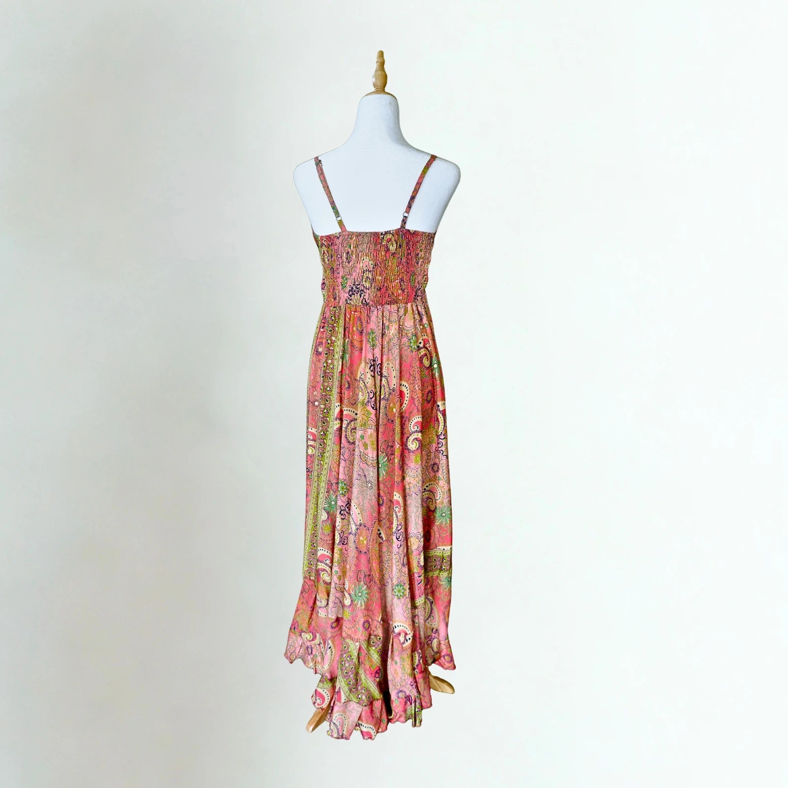 coral pink silk dress on mannequin with white background